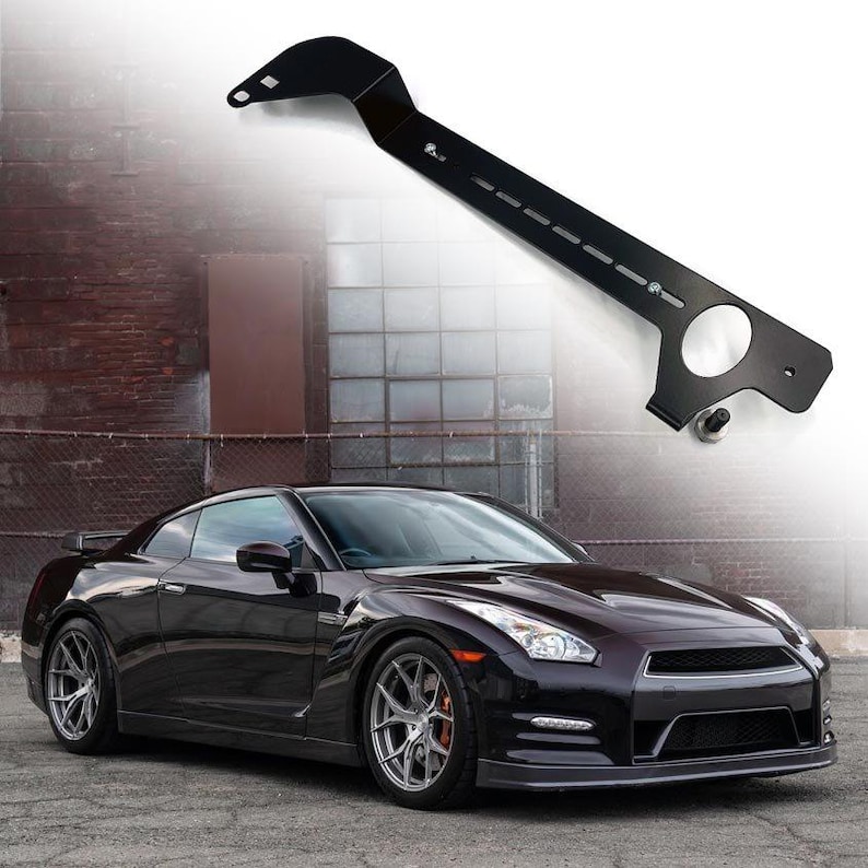 Fire extinguisher holder bracket for cars, shown above a Nissan GTR R35 for automotive interior mounting.