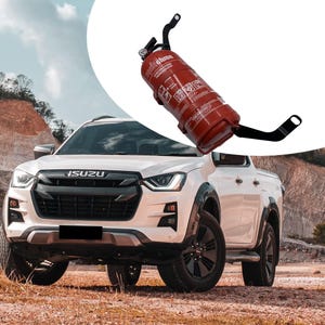 May include: A white Isuzu pickup truck parked on a dirt road. The truck has a black grill with the word "ISUZU" in the center. There is a red fire extinguisher mounted on the side of the truck.