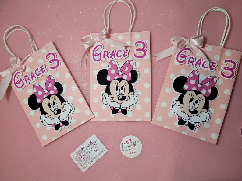 May include: Three pink and white polka dot gift bags with Minnie Mouse character and the name "Grace 3" on each bag.