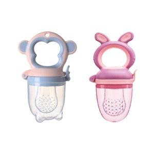 May include: Two silicone baby food feeders, one shaped like a monkey with pink ears and a blue handle, the other shaped like a bunny with pink ears and a purple handle. Both feeders have a clear plastic mesh section for holding food.
