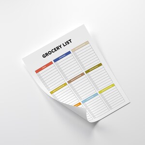 May include: A white grocery list notepad with the title "GROCERY LIST" in black. The notepad has sections for fruits, vegetables, and other food categories, each with a different colored header. The notepad is on a white surface.