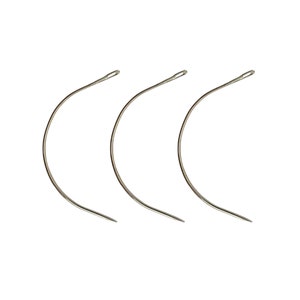 May include: Three silver curved needles for sewing leather.