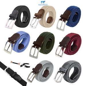 Op de afbeelding: Een verzameling elastische geweven riemen in verschillende kleuren, waaronder zwart, beige, blauw, groen en bordeauxrood. Elke riem heeft een zilverkleurige gesp en een leren accent bij de gesp.