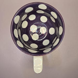 May include: A white ceramic mug with a black handle and the text "But First, Coffee" in a bold, black font. The mug is likely 4 inches tall and holds approximately 12 ounces of liquid. Perfect for enjoying your morning coffee or tea.