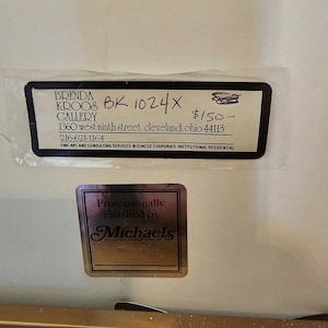 May include: A black and white sign with the text "BRENDA KROOB GALLERY" and "BK 1024X $150." The sign also includes the address "1360 west ninth street cleveland, ohio 44113" and the phone number "216-621-1164". The sign also includes the text "FINE ART AND CONSULTING SERVICES-BUSINESS-CORPORATE-INSTITUTIONAL-RESIDENTIAL".