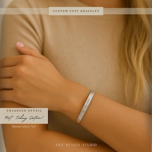 May include: A silver cuff bracelet with the text "Not Today Satan!" engraved on the outside. The bracelet is shown on a person's wrist. The image also includes the text "Custom Cuff Bracelet" and "Enlarged Detail".