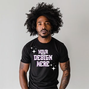 May include: A black t-shirt with the text "YOUR DESIGN HERE" in white with purple outlines and white stars.