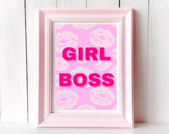 May include: A pink framed print with a pink background and white lip print pattern. The text "GIRL BOSS" is in bold, pink letters.