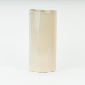 May include: A tall, off-white ceramic vase with a cylindrical shape. The vase has a slightly textured surface and a unique, uneven top edge. The neutral color and simple design make it a versatile piece for home decor.