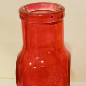 May include: A red glass bottle with the text "Dr. Foster Clark's Maidstone" embossed on the side.