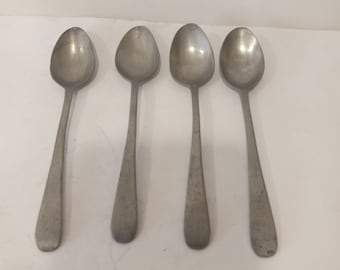 May include: Four silver spoons with rounded bowls and long, slender handles.