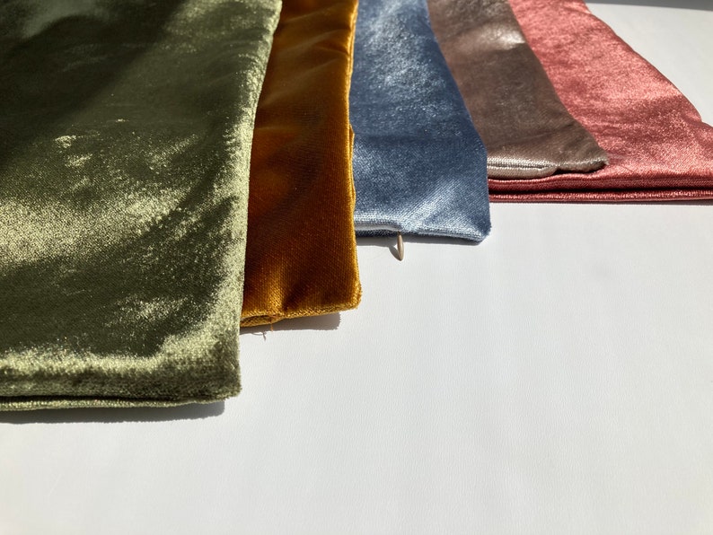 May include: Five velvet fabric swatches in different colors: olive green, mustard yellow, light blue, taupe, and dusty rose.