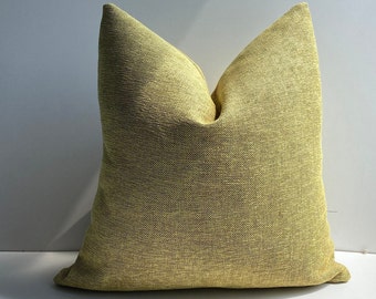 May include: A yellow throw pillow with a textured fabric.