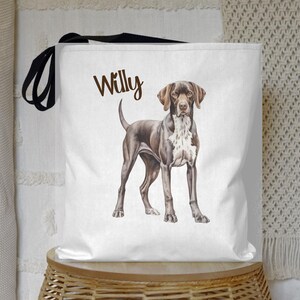 May include: White canvas tote bag with a black strap and a brown and white German Shorthaired Pointer dog illustration. The dog is looking at the camera and the text "Willy" is printed above the dog.
