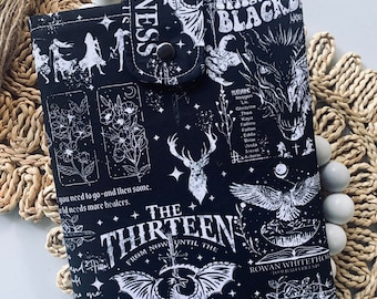 May include: Black and white fabric pouch with a zipper closure. The pouch features a repeating pattern of a dragon, a deer, a bird, and a book. The text "The Thirteen from now until the darkness" is printed on the pouch.