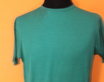 May include: A plain green t-shirt on a mannequin.