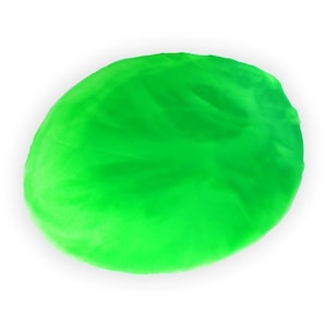 May include: Bright green, oval-shaped plush pillow against a white background. The pillow has a soft, textured appearance, with subtle variations in the green color. The overall shape is slightly irregular, suggesting a handmade or organic form.