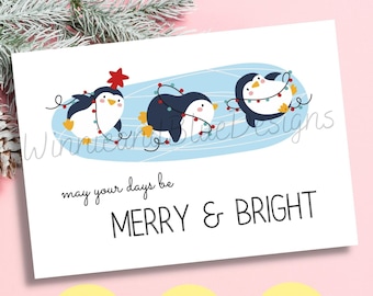 Può includere: Un biglietto di Natale stampabile con tre pinguini che indossano luci di Natale. Il biglietto ha il testo "may your days be MERRY & BRIGHT".