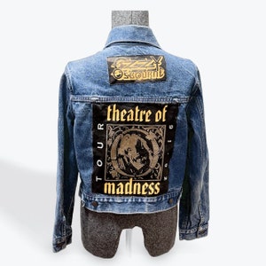 May include: A blue denim jacket with a black and gold patch that says "Ozzy Osbourne" and another patch that says "Tour 1986 Theatre of Madness".