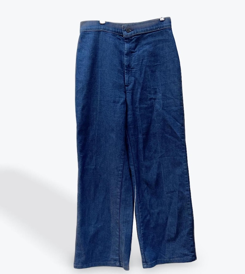 May include: A pair of dark blue denim jeans with a high waist and a straight leg.