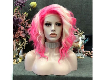 May include: A mannequin head displaying a pink and white wig with wavy, shoulder-length hair. The wig features a vibrant pink hue at the roots and ends, blending into a soft, creamy white. The mannequin wears a rhinestone choker.