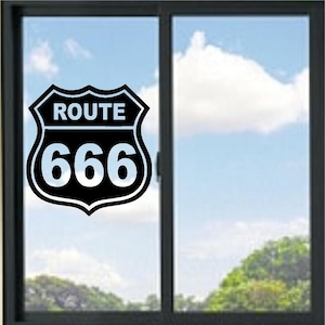 May include: A black and white vinyl decal shaped like a highway shield sign. The decal features the word ROUTE in white capital letters at the top and the number 666 in large white digits below, all enclosed within a black shield-shaped border.