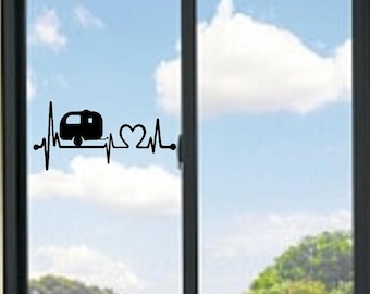 May include: A black vinyl decal applied to a glass window, featuring a continuous heartbeat line graphic that incorporates a silhouette of a travel trailer and a heart shape, creating a singular, connected design element.