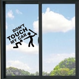 May include: A black vinyl decal sticker applied to a window, featuring the text DON'T TOUCH MY CAR in bold capital letters. The design includes a stick figure standing with a spiked club and another stick figure kneeling on the ground.