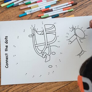 May include: A black and white connect-the-dots activity sheet with two images: a football helmet and a football. The sheet has the text "Connect the dots" printed on the left side.