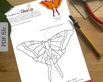 May include: A black and white line drawing of a moth with numbered sections for stained glass crafting. The pattern is approximately 19 x 12 inches. The text "This pattern may not be shared online, reproduced or resold* You can use this pattern to make stained glass pieces for personal use or to sell" is at the bottom of the page.