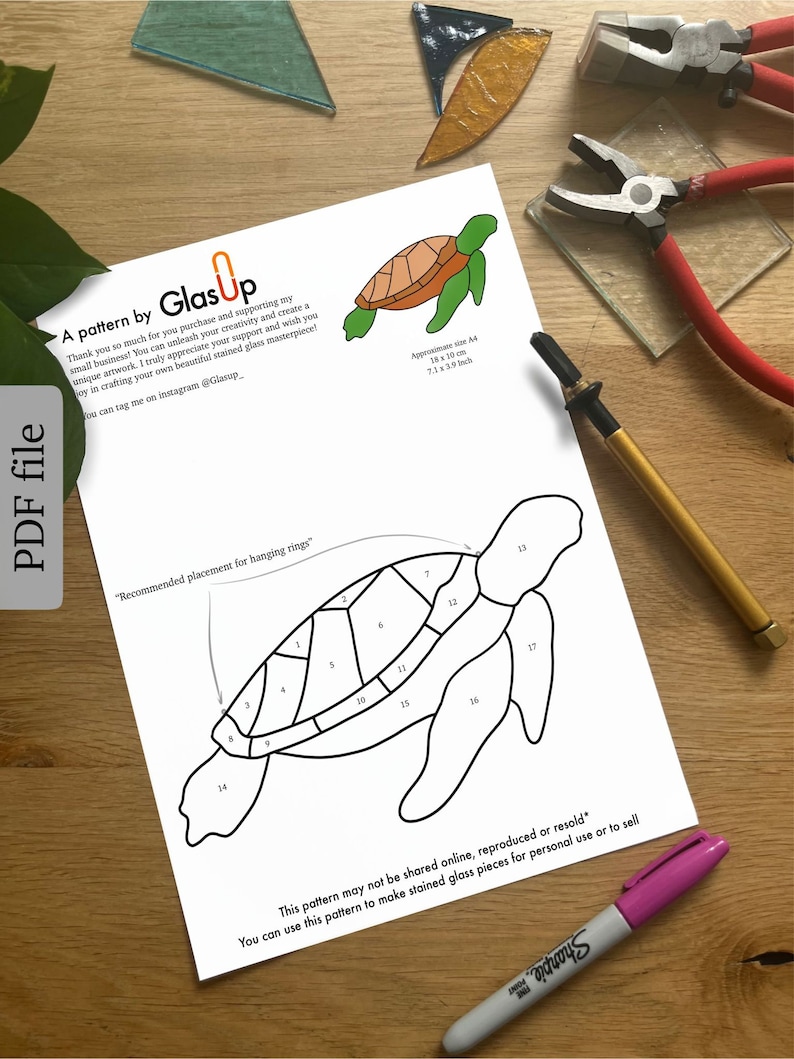 May include: A black and white line drawing of a sea turtle, with numbers on each section of the shell. The text "Recommended placement for hanging rings" is written above the turtle. The text "This pattern may not be shared online, reproduced or resold* You can use this pattern to make stained glass pieces for personal use or to sell" is written below the turtle.