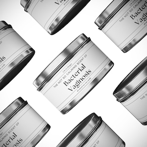 May include: A set of six silver metal candle tins with white labels. The labels have black text that reads "The Not So Calming Scent of Bacterial Vaginosis" and "All-natural soy wax candle".