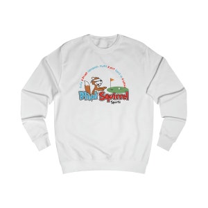 May include: White long-sleeve sweatshirt with a cartoon squirrel wearing a blindfold and holding a golf club. The text "Even a blind squirrel finds a nut once in a while" is written in a circle around the squirrel. The text "Blind Squirrel Sports" is written below the squirrel.