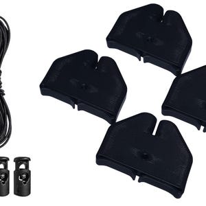 May include: A collection of black cord locks, black cord, and four black plastic cord end pieces. The cord is bundled in a loop. The cord locks are small and cylindrical.