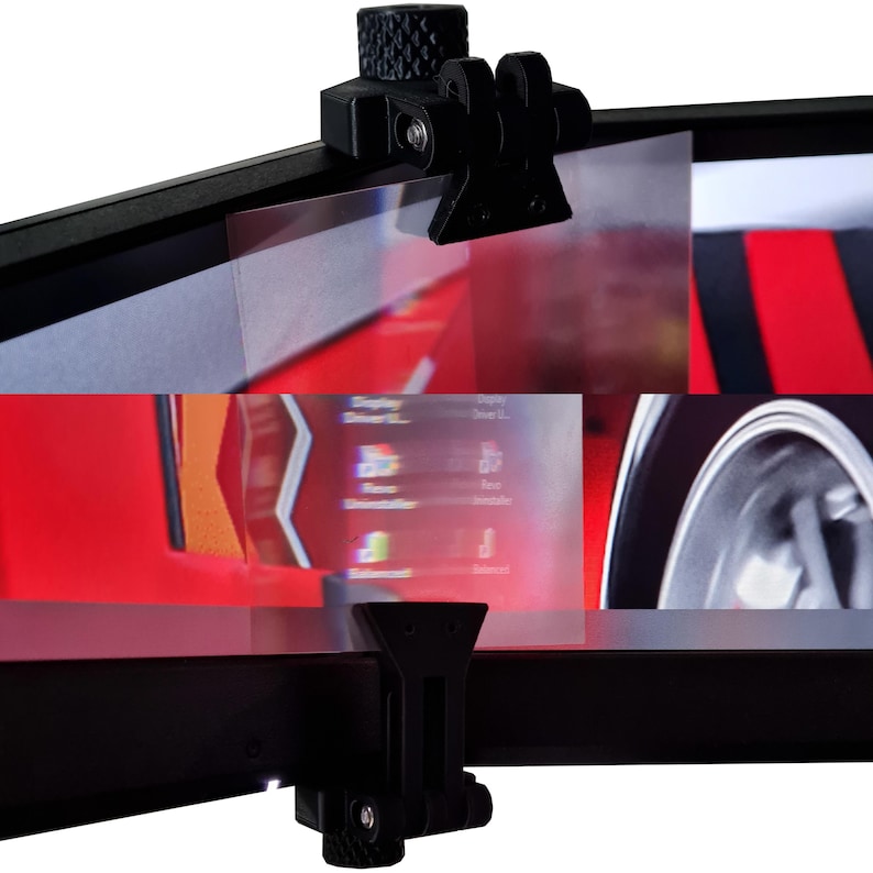 May include: Black plastic camera mount with a textured knob and adjustable arms. The mount is attached to a black bar, with a screen visible behind the clear plastic. The screen displays a red background with a car.