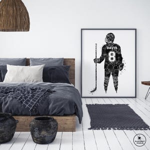 May include: Black and white illustration of a hockey player wearing a jersey with the number 8 and the name "DAVIS" on the back. The player is holding a hockey stick and is standing on a white background.