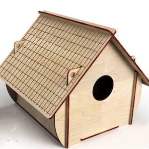 May include: A wooden birdhouse with a shingled roof and a round entrance hole. The birdhouse is painted in a light brown color and has a natural wood finish.