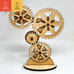May include: A wooden gear sculpture featuring four gears of varying sizes and shapes. The gears are interconnected and rotate when the sculpture is moved. The sculpture is crafted from natural wood and has a rustic appearance.