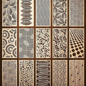 May include: A collection of fifteen rectangular wooden panels with intricate laser-cut designs. The panels feature various patterns, including leaves, geometric shapes, and floral motifs. The wood has a light brown color, and the designs are cut out to reveal the background.