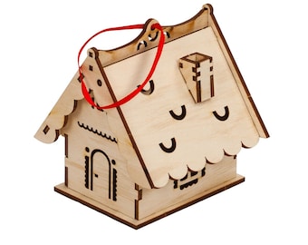 May include: A wooden gingerbread house ornament with a red ribbon for hanging. The house has a chimney and scalloped roof with cut-out details.