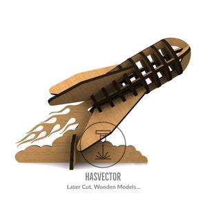 May include: A brown wooden rocket ship model with flames and a cloud base. The rocket is made of laser cut wood and has a detailed design. The model is ready to be assembled. HASVECTOR Laser Cut, Wooden Models...
