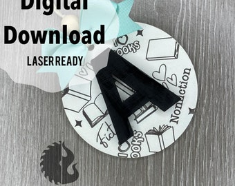 May include: A laser-cut wooden ornament with a black letter A in the center. The ornament is decorated with a white background and black illustrations of books, hearts, and the words "I love books", "Fiction", and "Nonfiction".