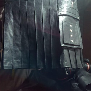 May include: A black leather kilt with multiple pockets and silver accents.