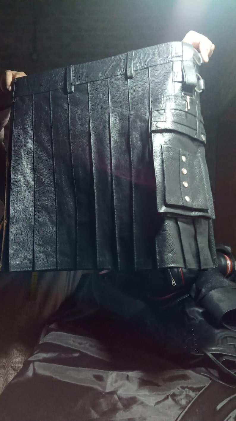 May include: A black leather kilt with multiple pockets and silver accents.
