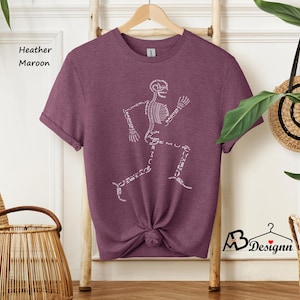 May include: Heather maroon t-shirt with a white skeleton graphic. The skeleton is running and has the names of the bones written on it.