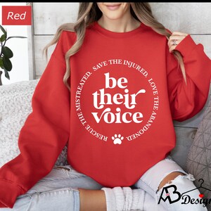 May include: Red sweatshirt with a white paw print and the text "Rescue the mistreated, save the injured, love the abandoned. Be their voice."
