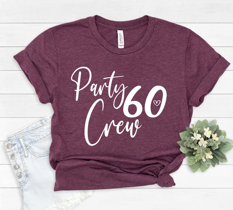 May include: A maroon t-shirt with the text "Party 60 Crew" in white lettering. The number 60 has a small white heart next to it.