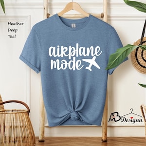 May include: A heather deep teal t-shirt with the text "airplane mode" in white with a white airplane icon.