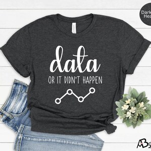 May include: Dark grey heather t-shirt with the text "data or it didn't happen" and a line graph graphic.
