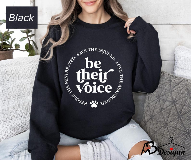 May include: Black sweatshirt with a white circle graphic that says "Be their voice" with a paw print in the center. The circle also says "Rescue the mistreated, save the injured, love the abandoned".